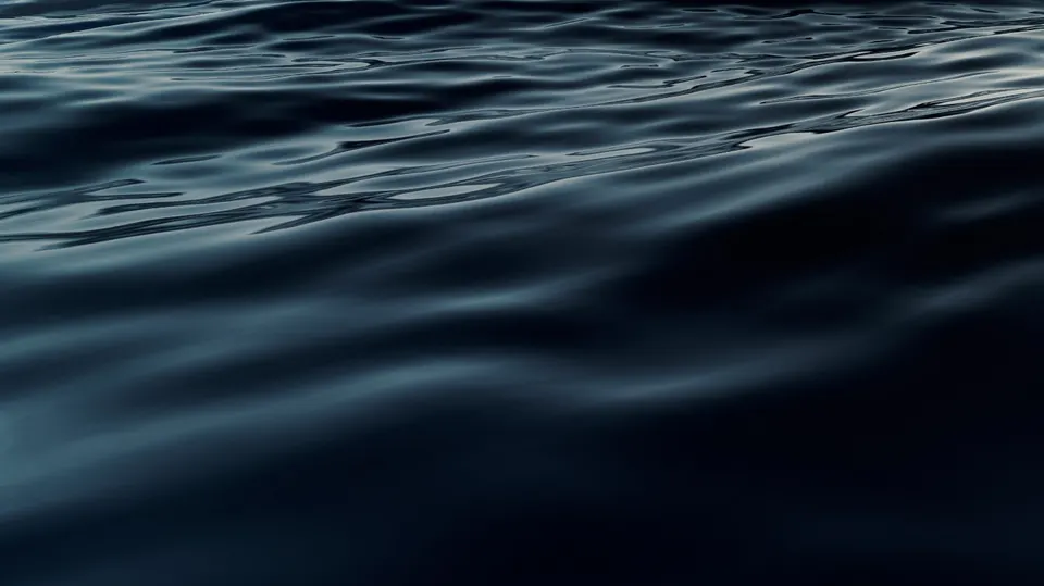A superfície escura do mar ao entardecer